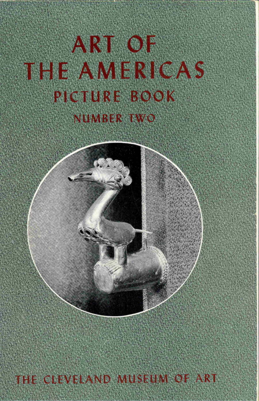 The cover of a green book titled “Art of the Americas: Picture Book Number Two.” Beneath the title there is a round black-and-white photograph of a bird-shaped metal object. At the base of the cover The Cleveland Museum of Art is written in red.